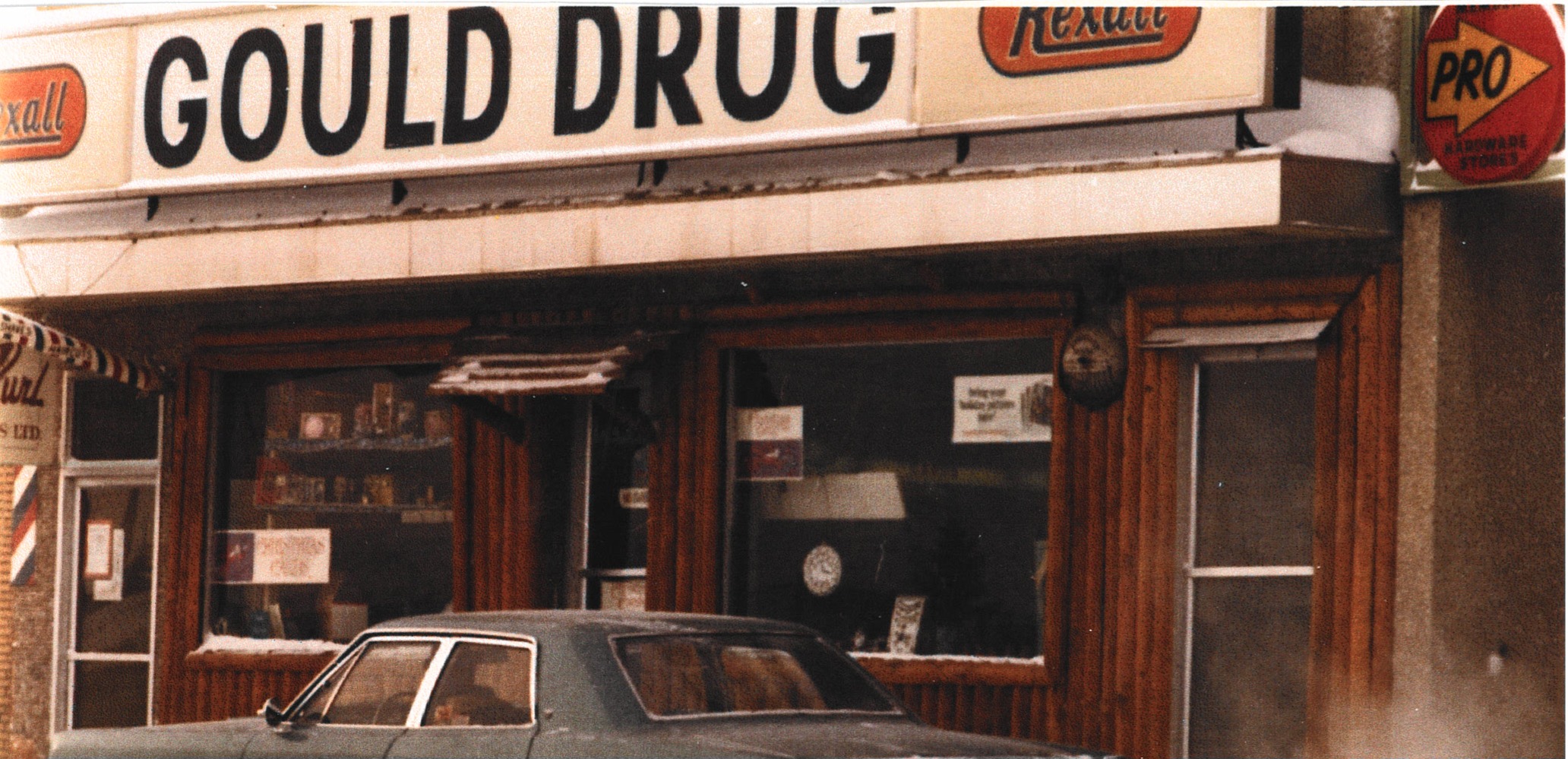 Close-up of the Gould Drug Rexall signage and storefront, 1970s
